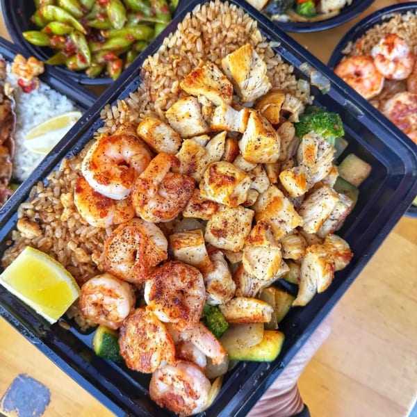 Habachihana Grill's chicken and shrimp hibachi with fried rice, vegetables, and a lime wedge.